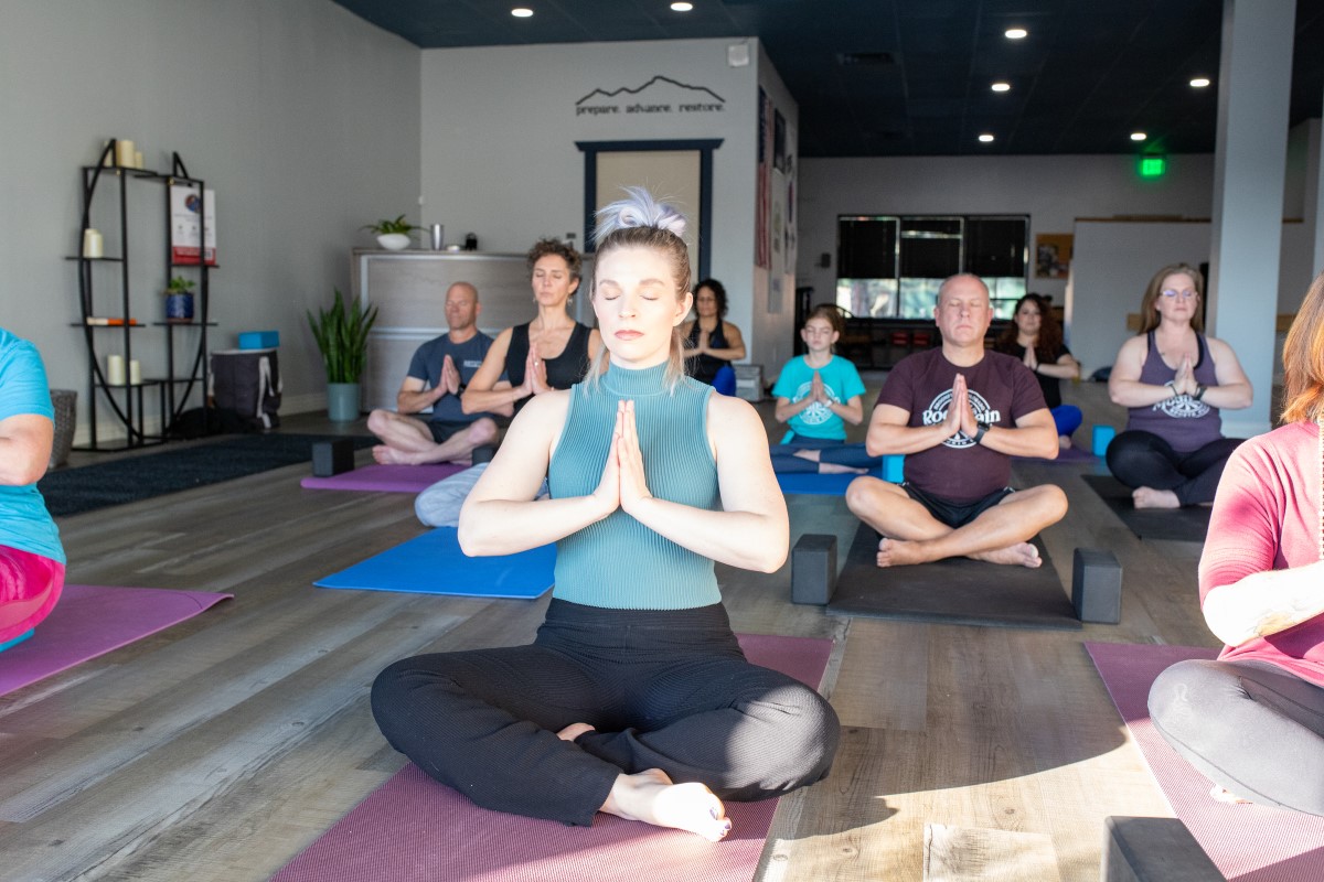 Woman in prayer yoga pose.