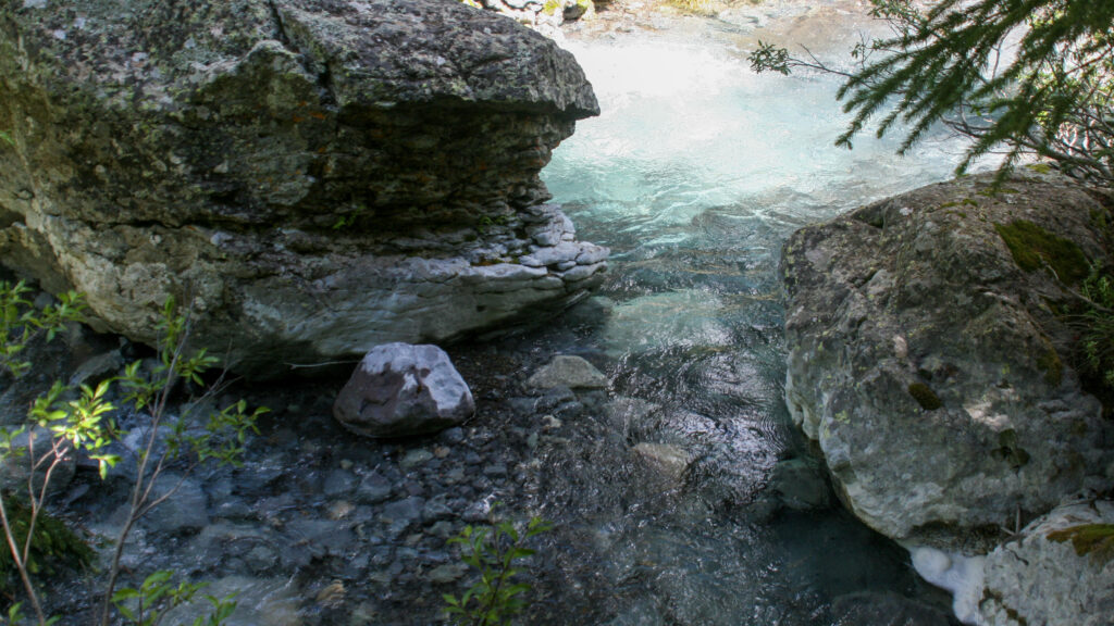 Water flowing between mountain rocks