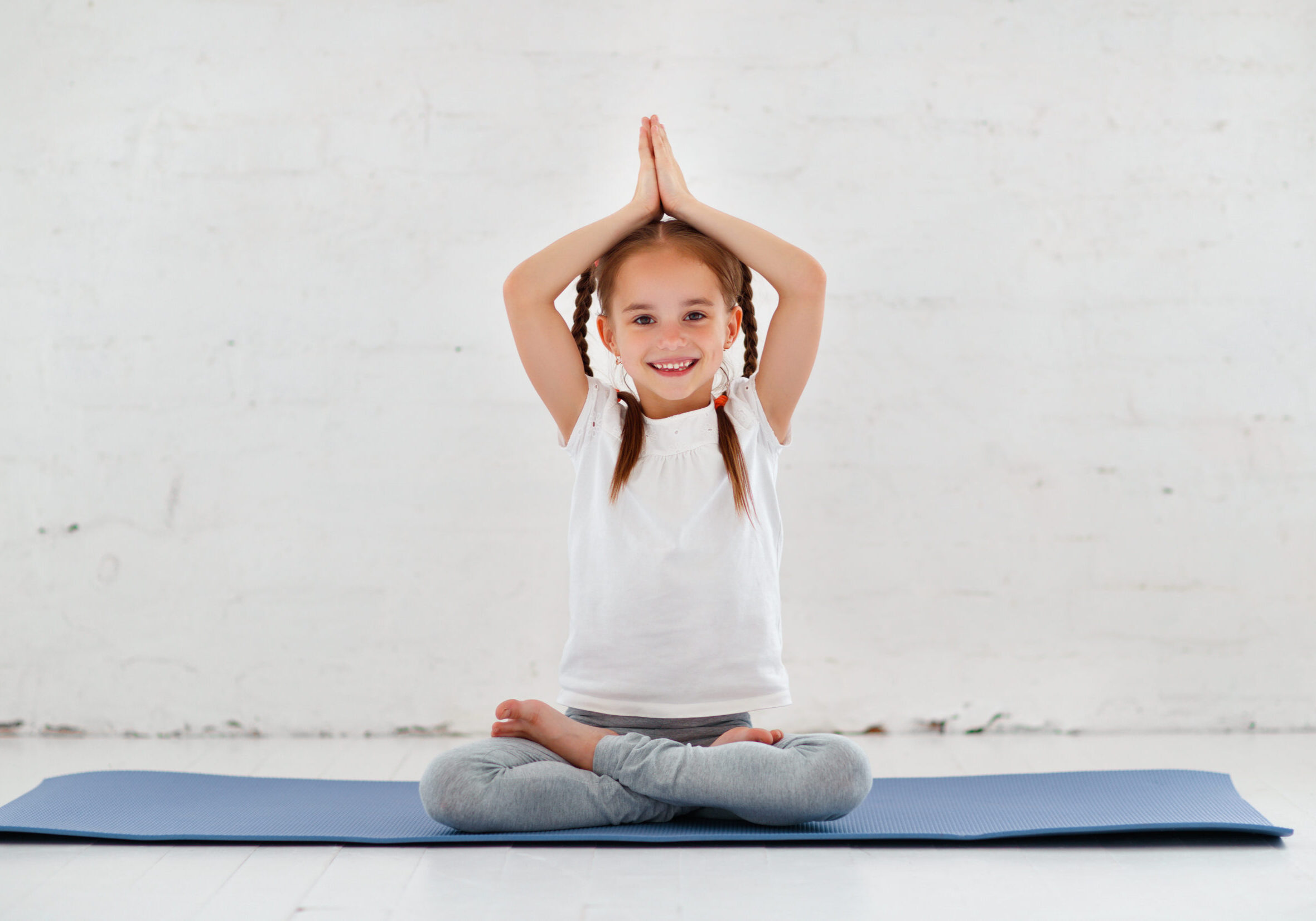 child girl doing yoga and gymnastics in the gym